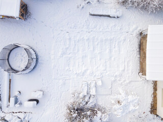 aerial drone flight over pool covered with tarpaulin in winter, snow, cold