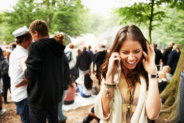 Woman, phone call and loud music festival for communication, conversation or networking in nature. Female person struggling to hear on mobile smartphone for discussion at outdoor concert or event - obrazy, fototapety, plakaty