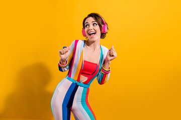 Photo of funky excited lady wear striped costume enjoying rock headphones looking empty space...