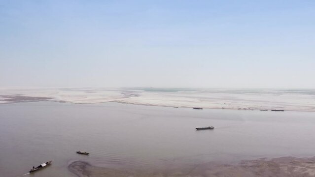 Aerial view of Jamuna river in dry season, fishing and passenger wooden boats in the winter