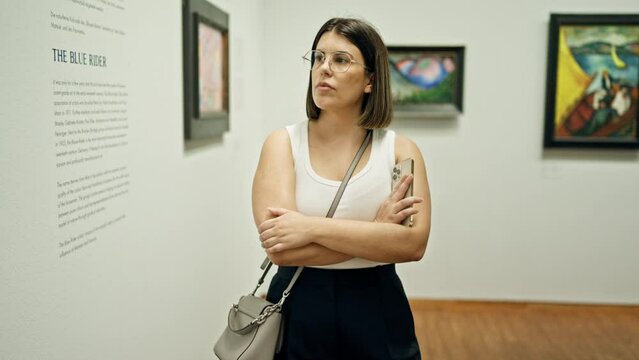 Young beautiful hispanic woman visiting art gallery at Albertina Museum in Vienna