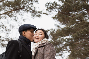 Fototapeta premium Young asian couple in love walking in winter park
