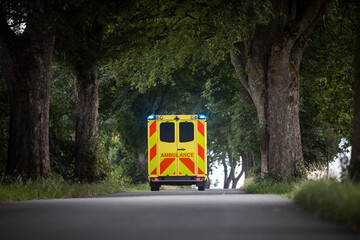 Yellow ambulance car of emergency medical service on country road. Themes rescue, urgency and health care. . © Chalabala