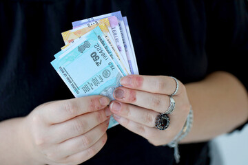 Woman hand with indian rupees bills close up. Concept of financial operations in cash in India
