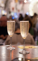 A beautiful crystal flutes of cold fresh Champagne with bokeh light festive in Background. It's well know as French sparkling wine. And its mark as wine of celebration 