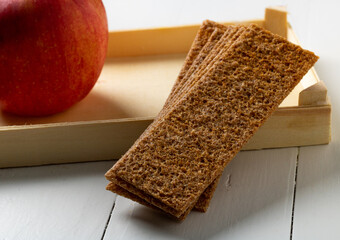 Rye bread and an apple, a healthy snack.