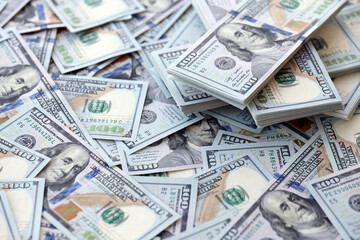 Very big amount of US hundred dollar bills close up. Huge quantity of united states currency notes on flat table