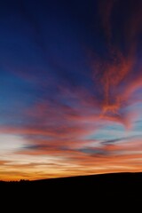 Sunset with clouds being painted in bright red color 