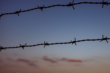 barbed wire in front of red sky during sunset (2)