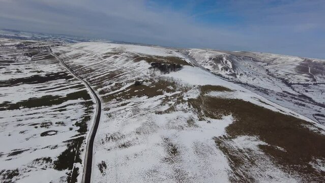Helicopter view of paragliders below winter landscape ice cold flying fun pleasure remote rural hills fields