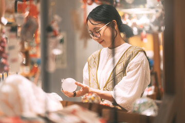 Asian woman choosing gift shop on Christmas and happy new year holidays