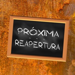 Square illustration written in Spanish “reopening soon” on a black slate with a rust-colored background	
