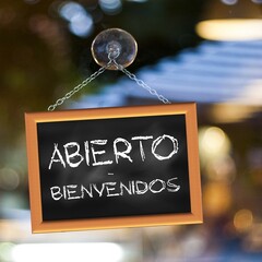 Square illustration written in Spanish Open Welcome on a black slate hung with a suction cup on a window	