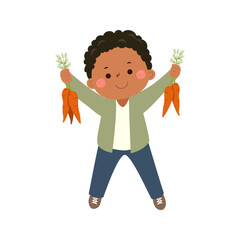 Little boy farmer holding carrots