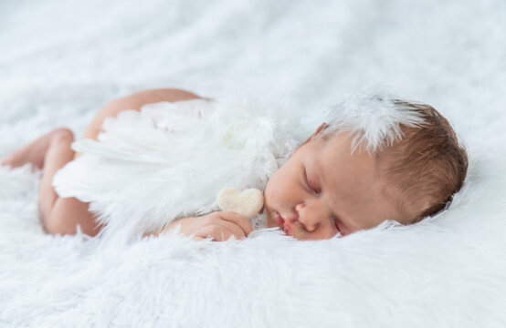 Newborn angel photo session in a suit. Selective focus