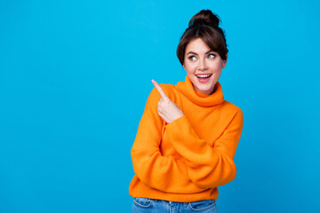 Photo of dreamy excited lady wear knitted pullover pointing finger looking empty space isolated...