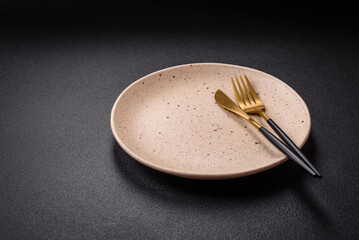 Bumpy empty ceramic plate on a textured concrete background