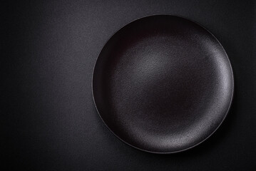 Bumpy empty ceramic plate on a textured concrete background