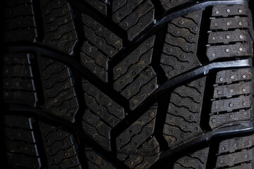 Studless snow tire close-up macro shot landscape - obrazy, fototapety, plakaty