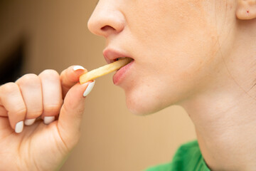 Closeup of woman eating fries