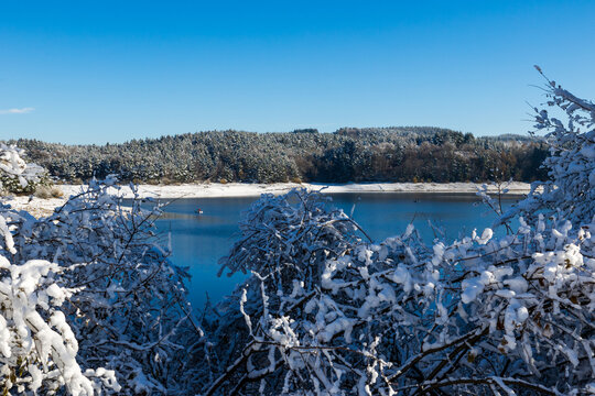 Lac de Lavalette entour&eacute;e d&rsquo;une for&ecirc;t de sapins, dans les Gorges du Lignon, sous les premi&egrave;res neiges de l&rsquo;hiver