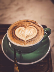 Hot cappuccino coffee in a mug Placed on the table in a warm atmosphere.