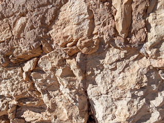 Abstract grunge background. Old brown rough stonewall texture.