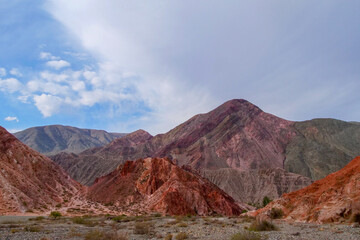 Picturesque hill of seven colors, Purmamarca, Argentina, mountain range with colorful purple and orange colors.