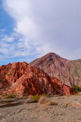 Picturesque hill of seven colors, Purmamarca, Argentina, mountain range with colorful purple and orange colors. Vertical image
