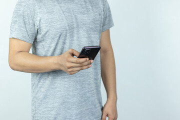 Asian man sending text message on smart phone on white Background