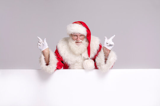 Happy Santa Claus with white empty board.