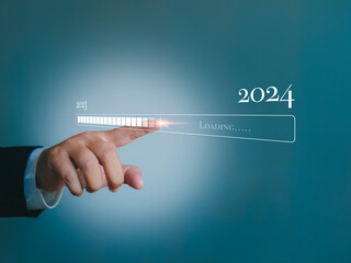 Business planning and strategy, hand tap on download bar status to change from 2023 to 2024....