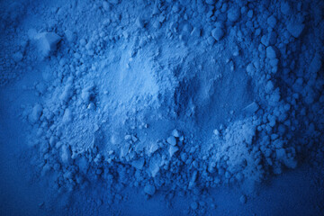 Top view of blue sand, captured in close-up detail, displaying textured grains.