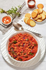 chakalaka, spicy tomato bean relish in white bowl