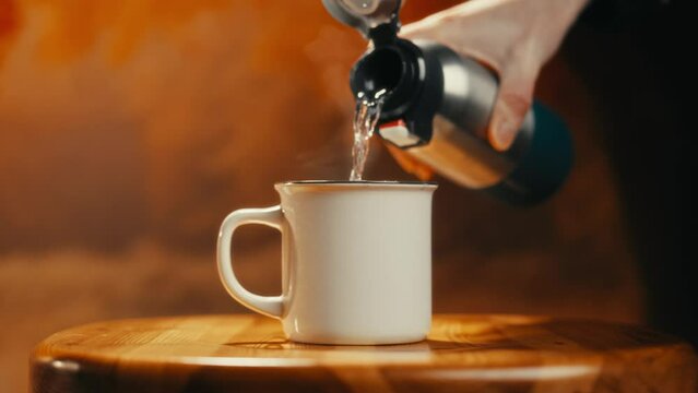 close-up of hot tea being poured into a tiny cup. Cinematic video. Ideal for those who love tea drinking.