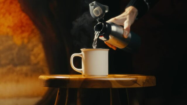 close-up of hot tea being poured into a tiny cup. Cinematic video. Ideal for those who love tea drinking.
