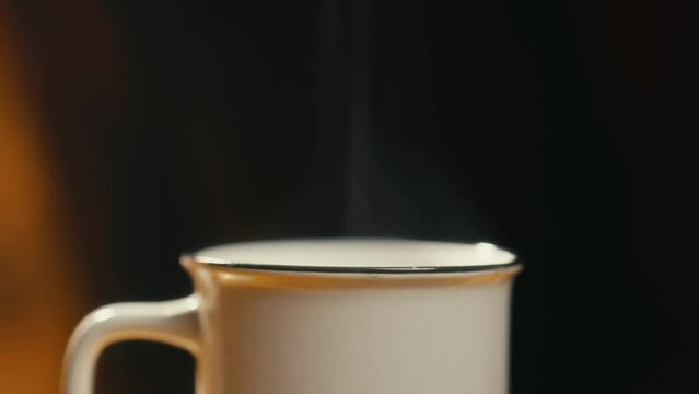 Hot coffee mug in the morning. Delicious drink to start the day. Steaming hot beverage.