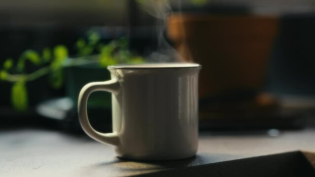Hot coffee mug in the morning. Delicious drink to start the day. Steaming hot beverage.