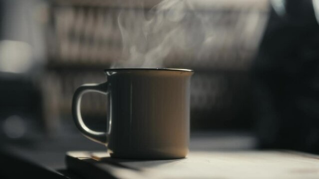 Hot coffee mug in the morning. Delicious drink to start the day. Steaming hot beverage.