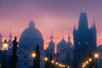 Misty mornig from Charles Bridge. Colorful sunrise over towers of Prague, Czech Republic..
