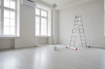 Foto op Canvas Empty unfurnished room with ladder and paint bucket. Unfinished living room interior with white walls, floor and windows. Renovation. Repairs in apartment. Empty interior space © Studio Romantic