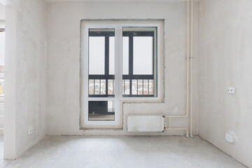 Fototapeta premium interior of the apartment without decoration in gray colors. rough finish