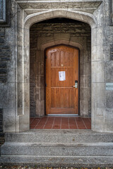 Fototapeta na wymiar wooden door in a stone carved alcove