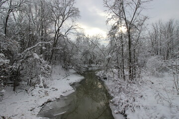 River in fall with snow covered trees