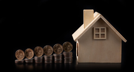 1 American dollar coins and a symbolic wooden house on a black background