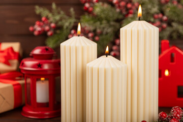 Christmas decoration with candle on texture background. New Year and Christmas candles. Cozy home decor. Burning candle and Christmas decoration. Christmas lights. Copy space.Holiday concept. 