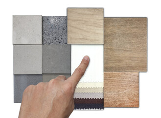 interior designer selects material samples including drapery fabric catalog, multi color and texture of wooden and stone ceramic tiles, terrazzo stones isolated on background with clipping path.