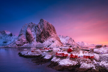 View on the house in the Hamnoy village, Lofoten Islands, Norway. Landscape in winter time during blue hour. Mountains and water. Travel image