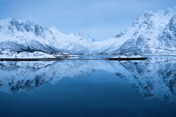 Lofoten islands, Norway. Mountains and reflection on water surface. Evening time. Winter landscape near the ocean. Norway travel - obrazy, fototapety, plakaty