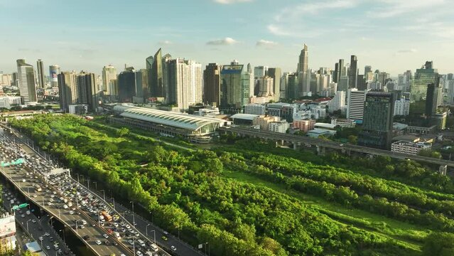 BANGKOK, THAILAND  Aerial drone view of electric train station and traffic in bangkok city centre from above.